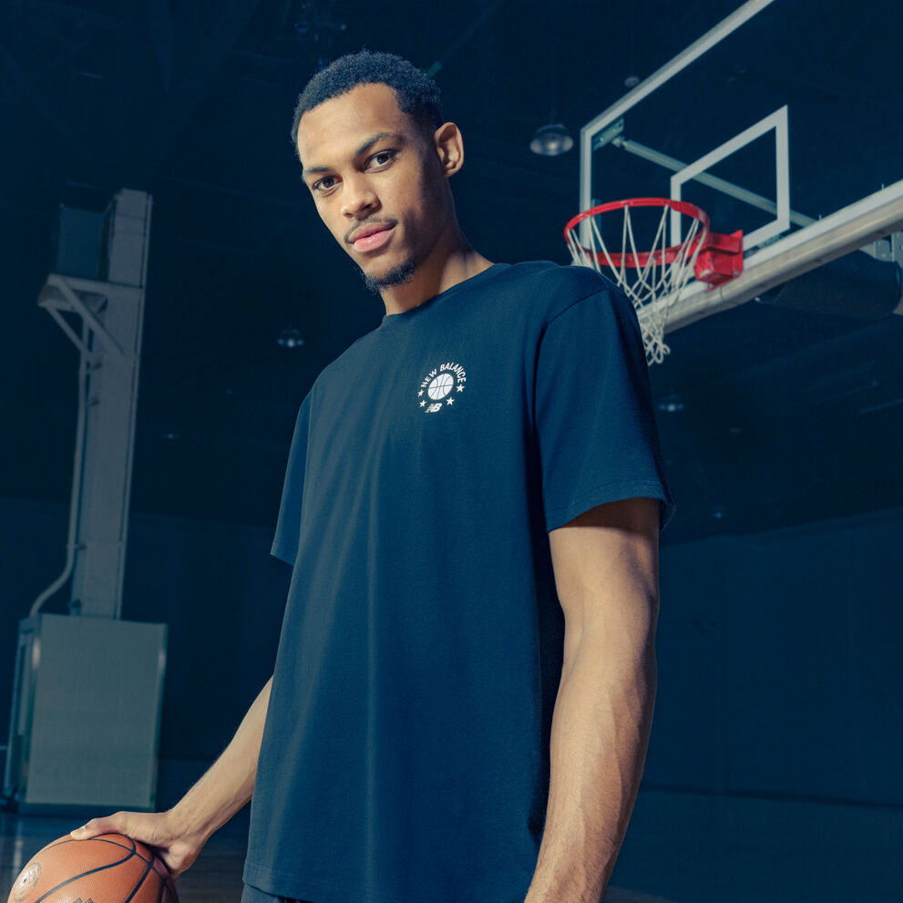 Darius wearing a navy tshirt standing under the bucket.