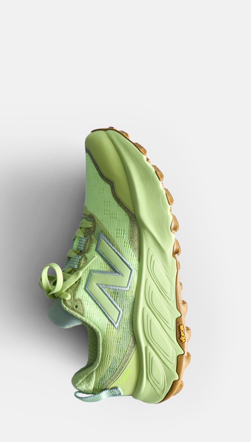 Light green sneaker with a thick sole and a New Balance logo, shown on a white background.