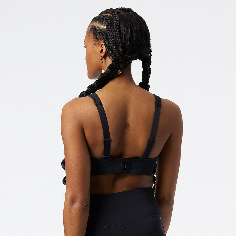 Back shot of a Woman wearing a black NB Breakthrough Bra in a studio environment.