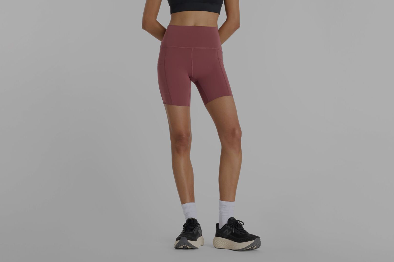 Person wearing red New Balance shorts.