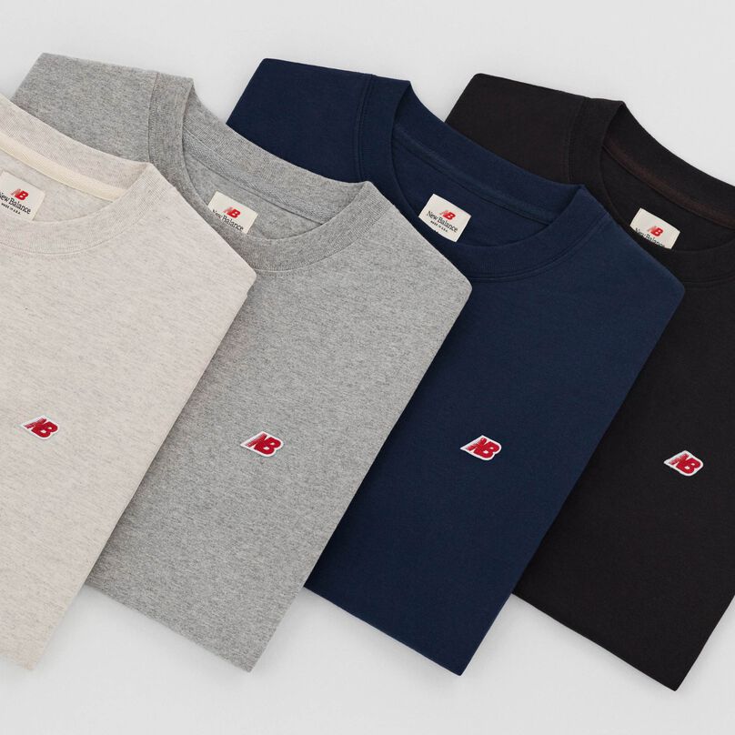 Grouping of MADE In USA short sleeve shirts stacked on top of each other.