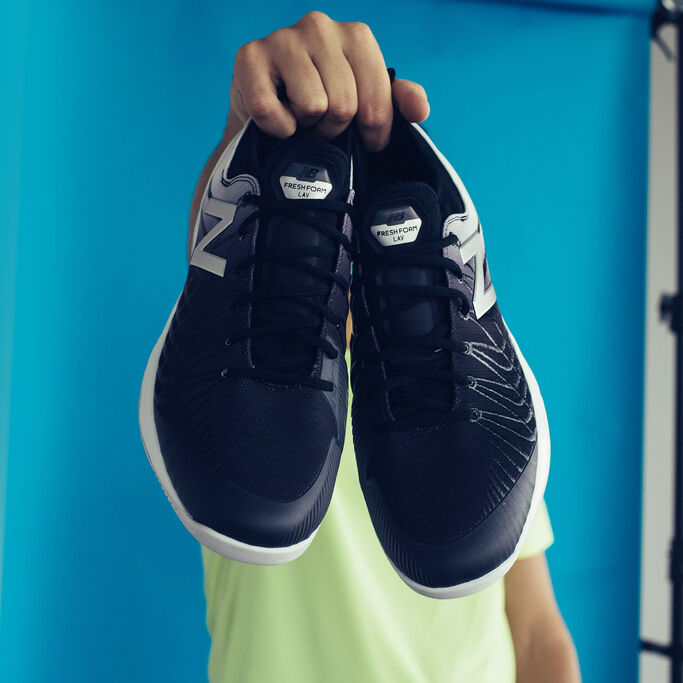 Milos holding the shoes in front of of the camera.