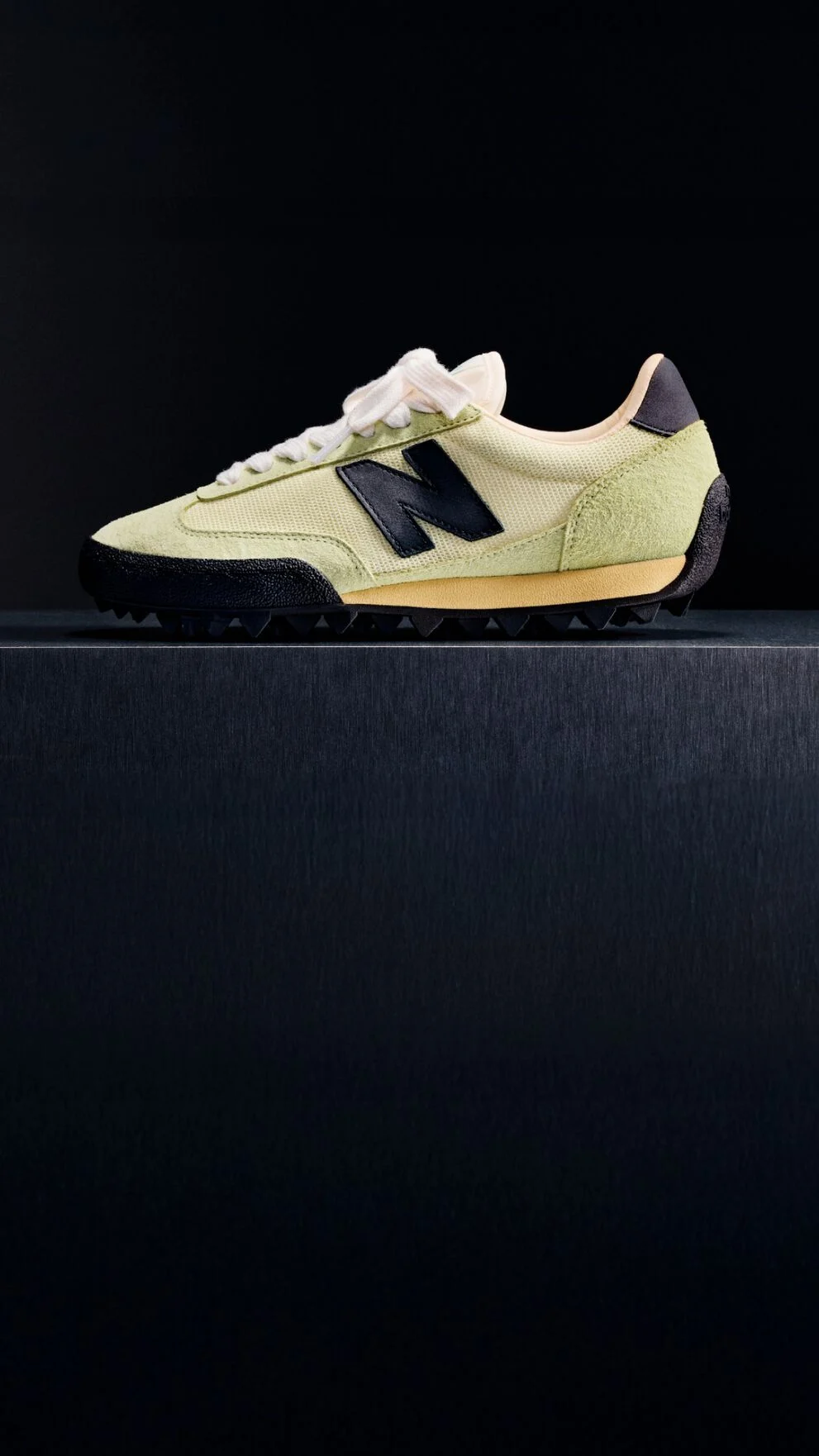  Single green sneaker on a black background 
