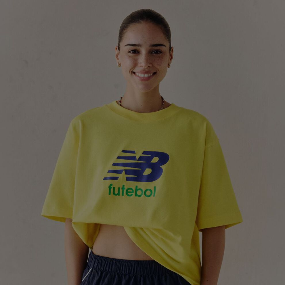 A woman wearing a New Balance graphic tee.