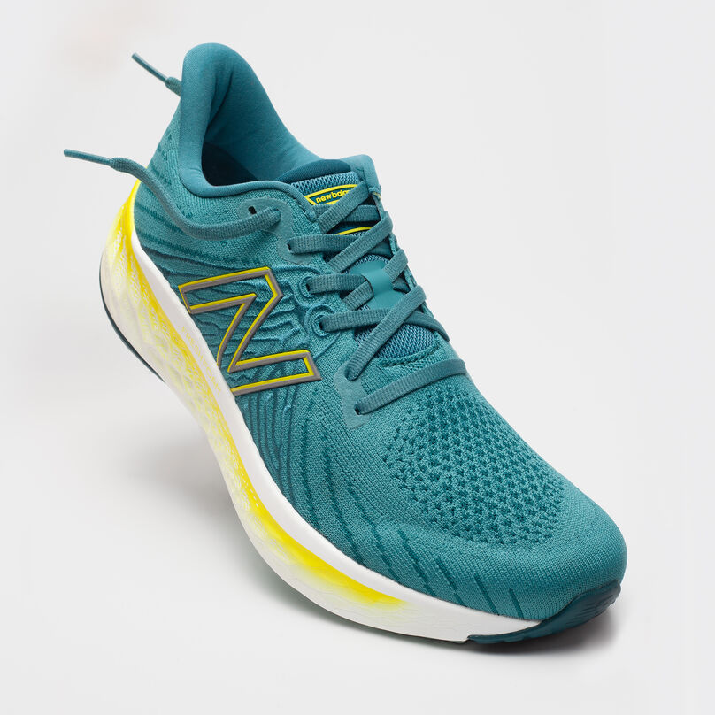Side profile of floating green Fresh Foam Vongo shoe on a grey background
