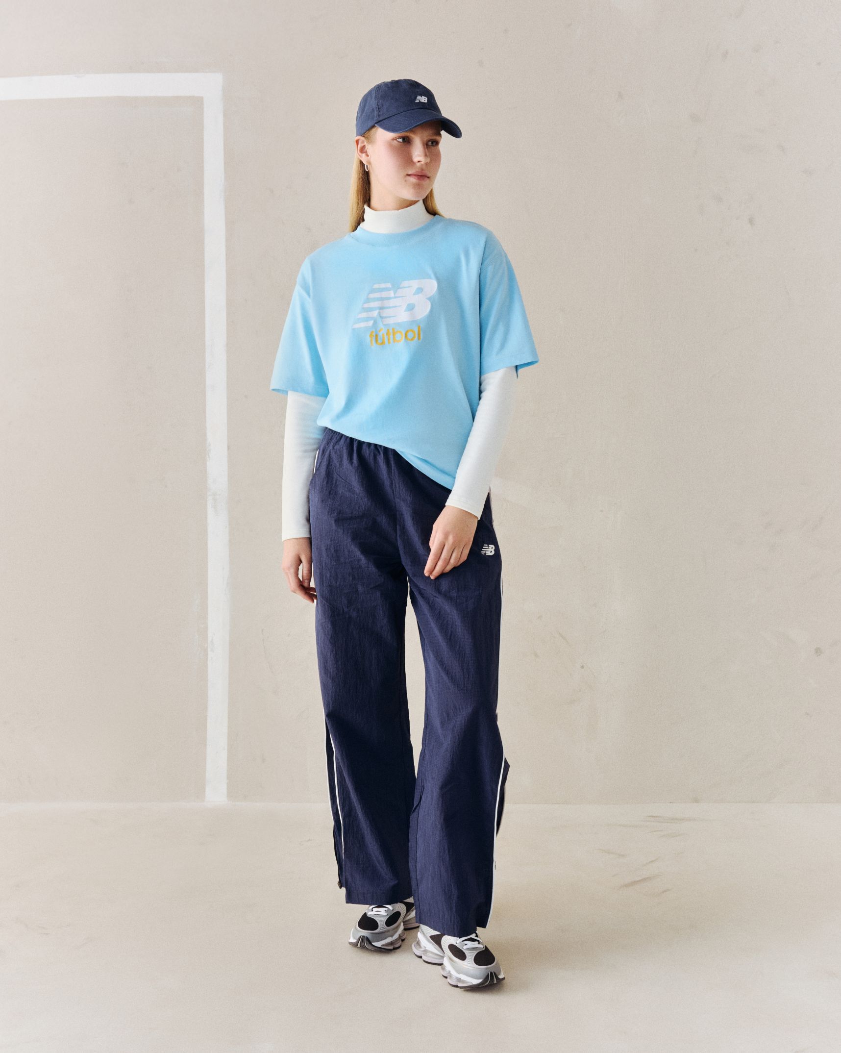A person wearing a blue soccer graphic tee.