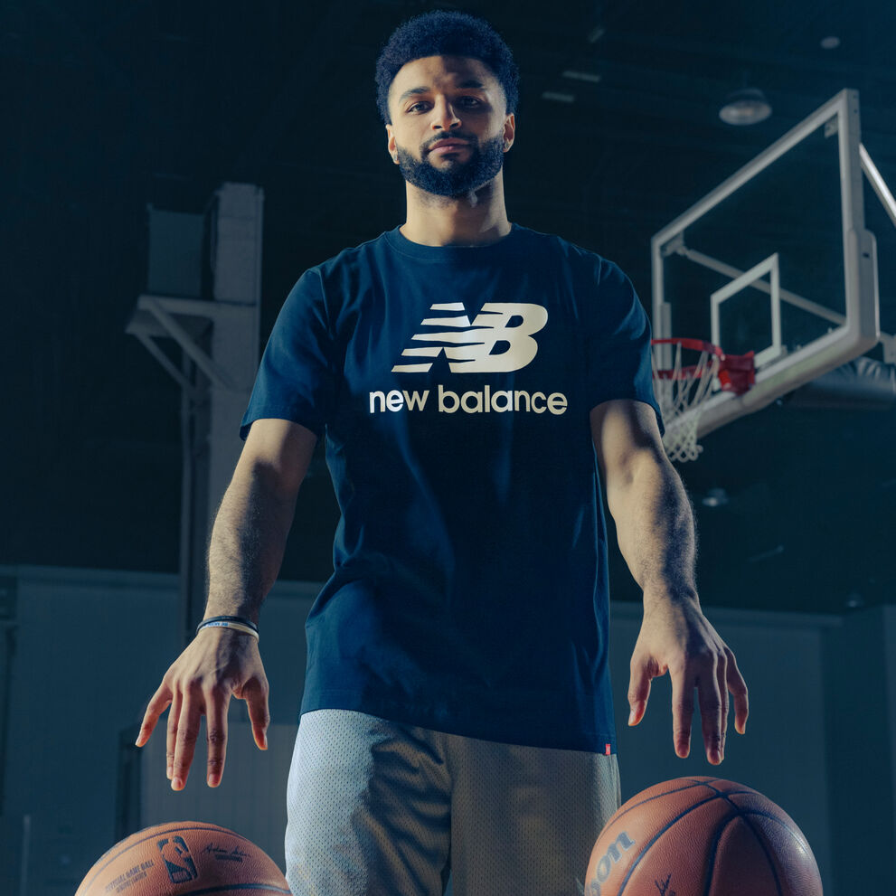 Jamal dribbling two basketballs on the hardwood.