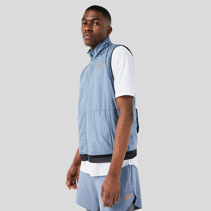 Man posing with his left shoulder in front to show the vest.