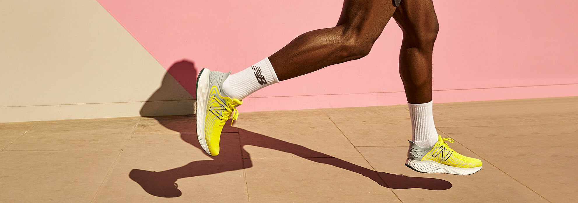 Knee down of male running wearing yellow Fresh Foam 1080 shoes