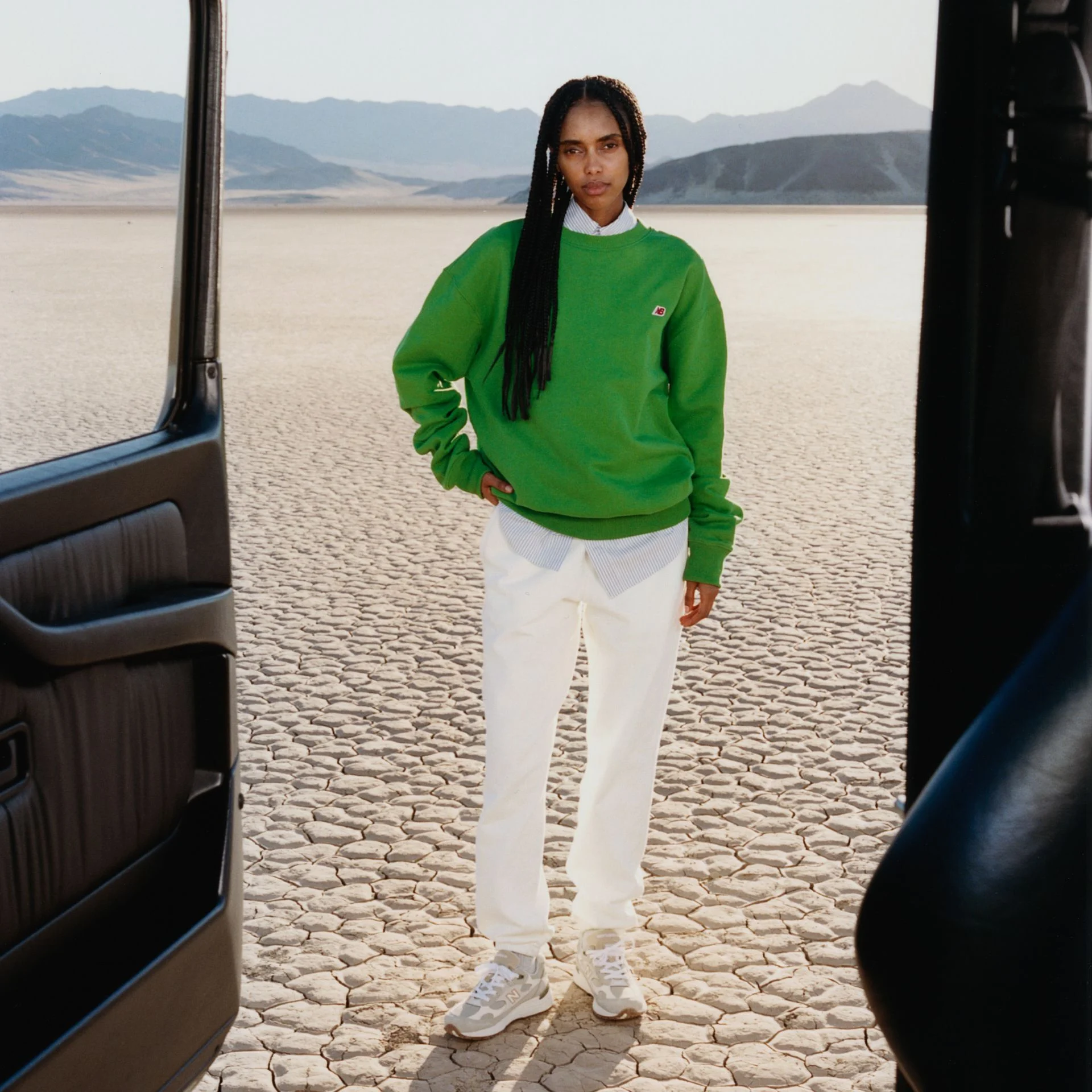 A woman standing in a desert environment.