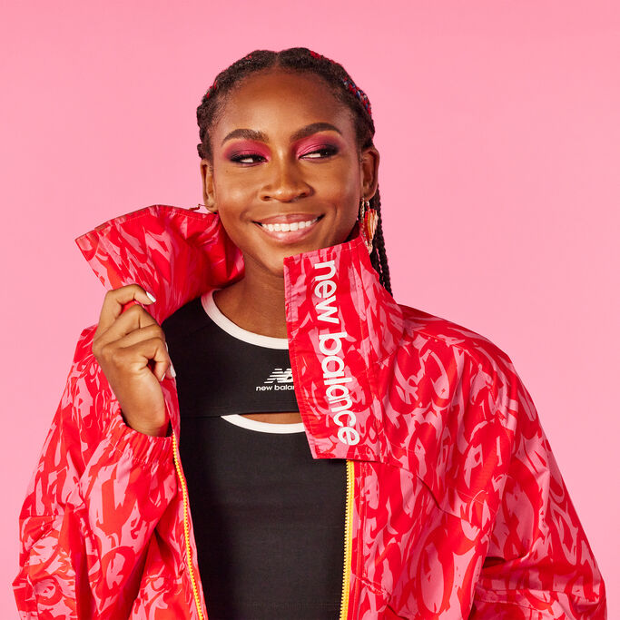 Coco Gauff standing with back to the camera, wearing a black tee