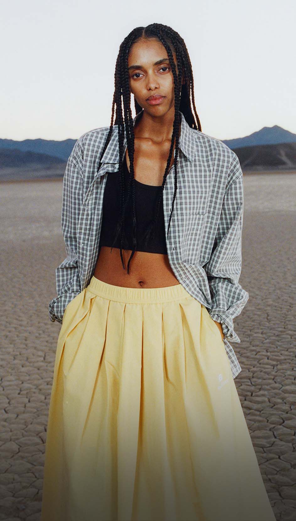 Une femme debout dans un environnement d&eacute;sertique.