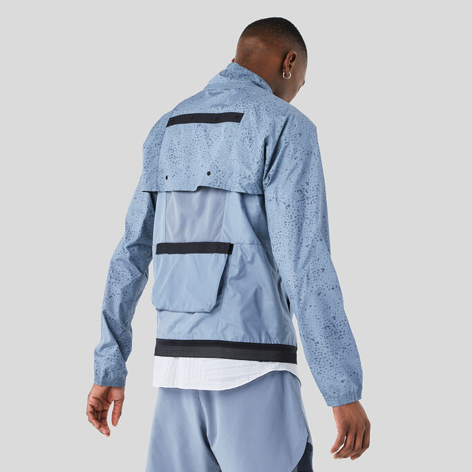 Young man with his back turned to show the storage on the back of the jacket.