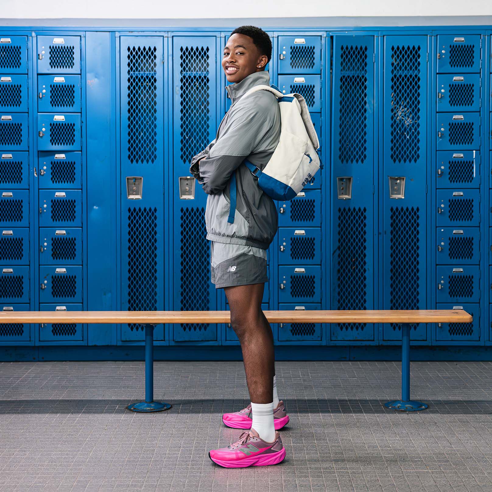 Quincy Wilson looking at the camera with NB logo overlay in the center