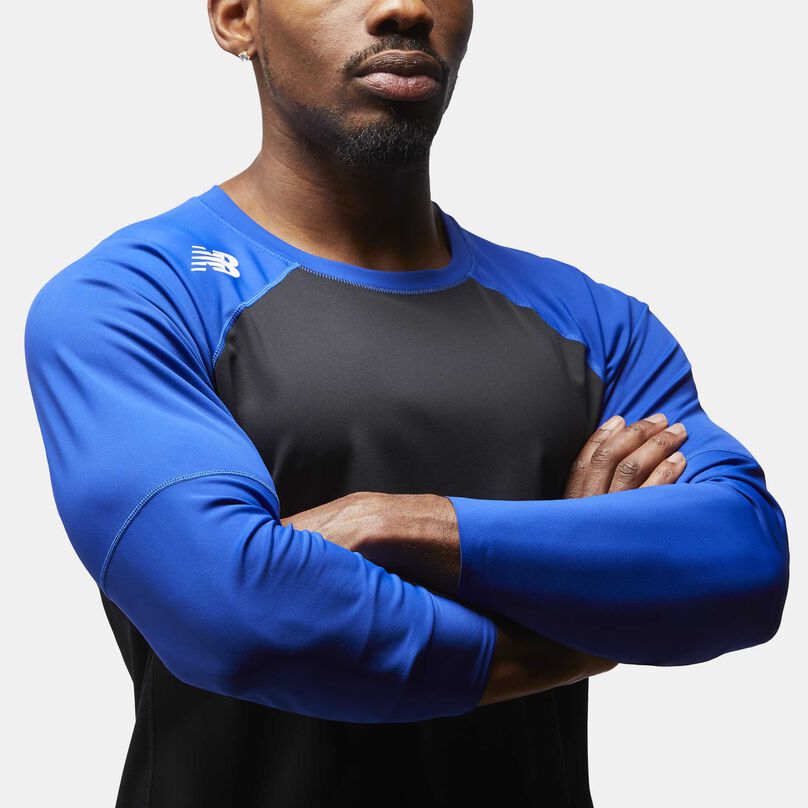 Man wearing blue top with arms crossed