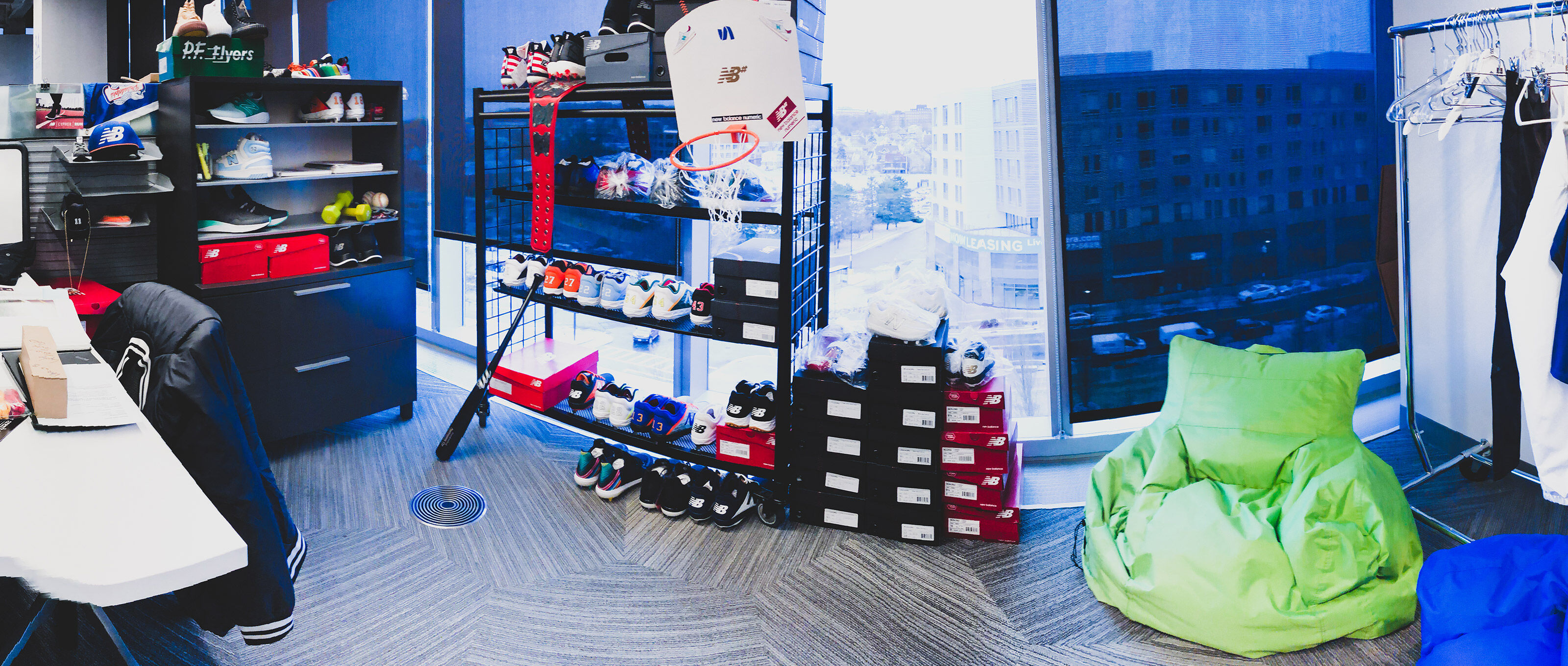 Inside of Darius’s workspace showing a basketball hoop and shoes.