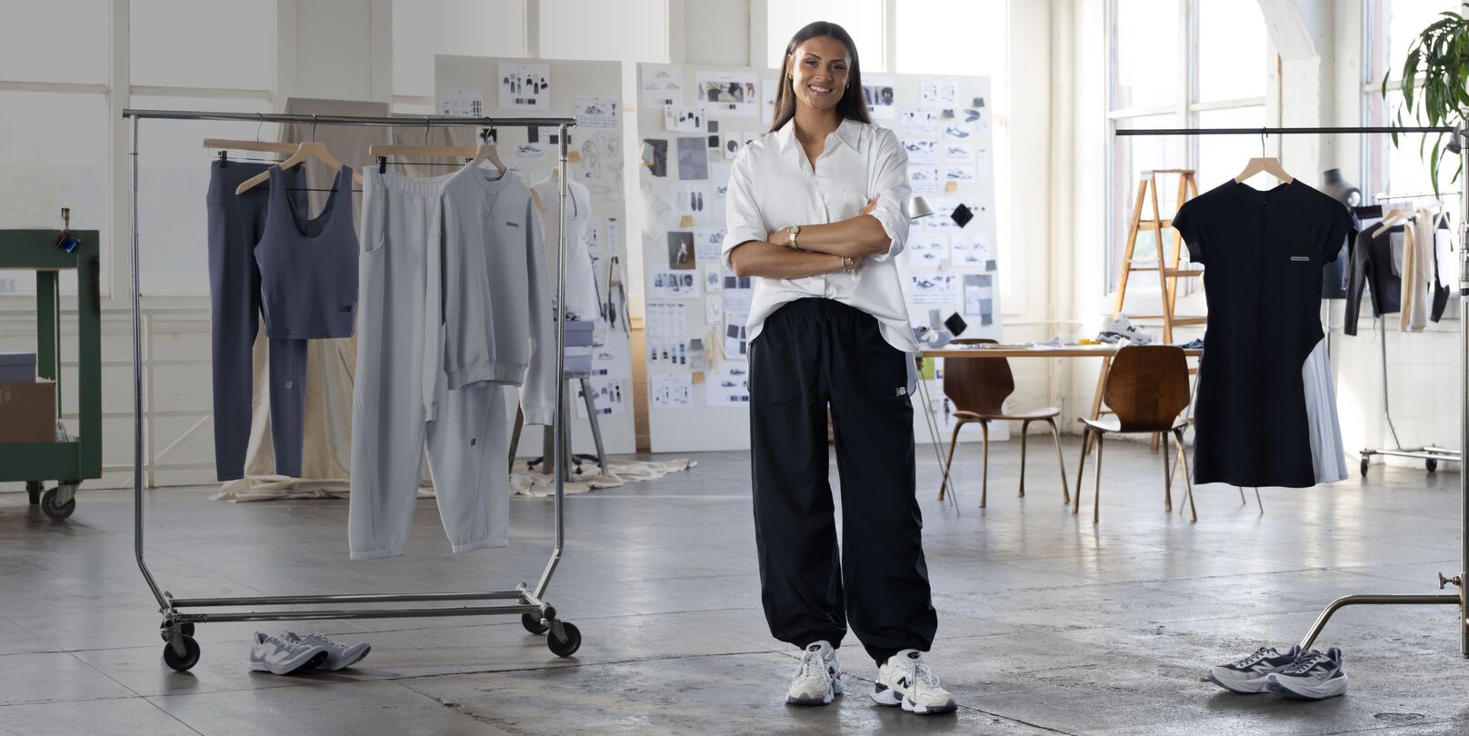  Sydney Levrone standing in front of her apparel collection.