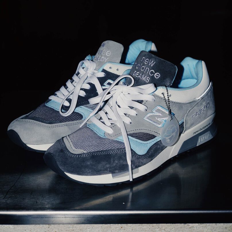 A pair of the Paper Boy and New Balance sneakers showing the unique color pattern.