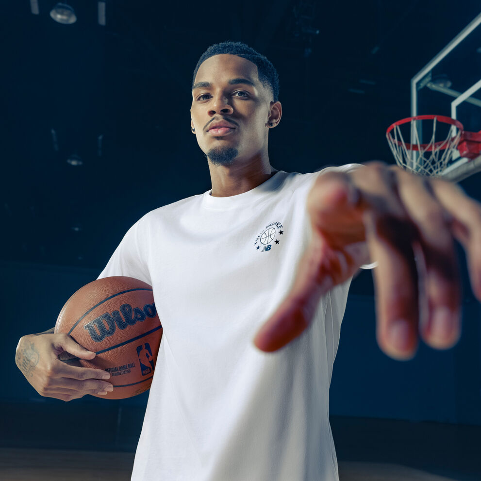 Dejounte pointing at the camera in a white tshirt.