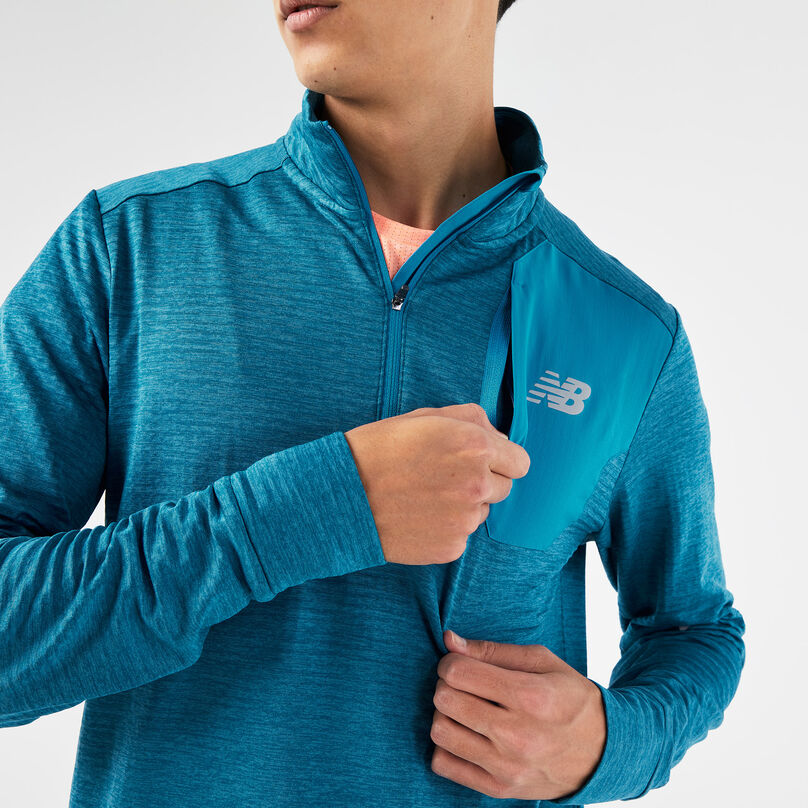Unzipping the front pocket on the left chest.