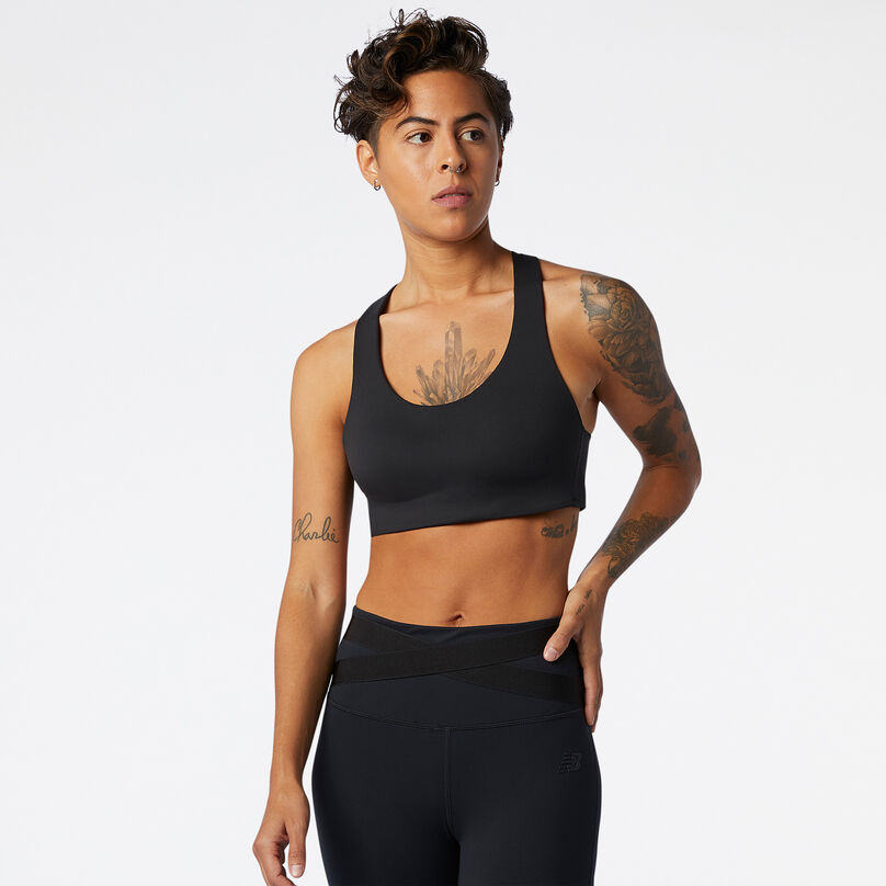 Woman wearing a black NB Fortiflow Bra facing the camera in a studio environment.