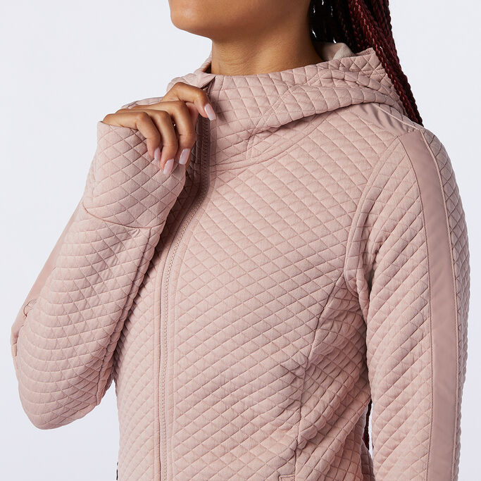 Woman wearing the Heatloft hoodie focusing on the square pattern.