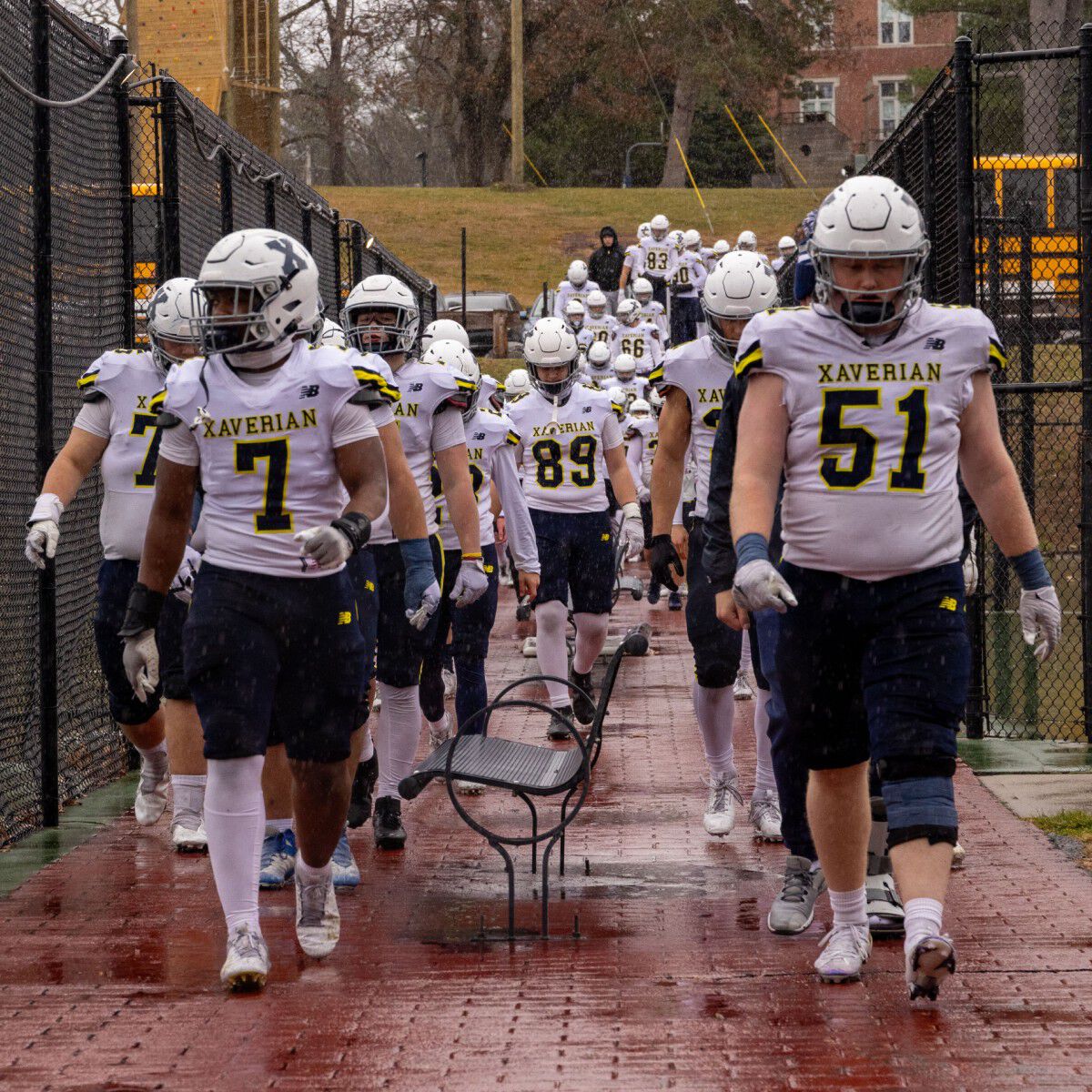 Entire team walking on the sidewalk to the field.