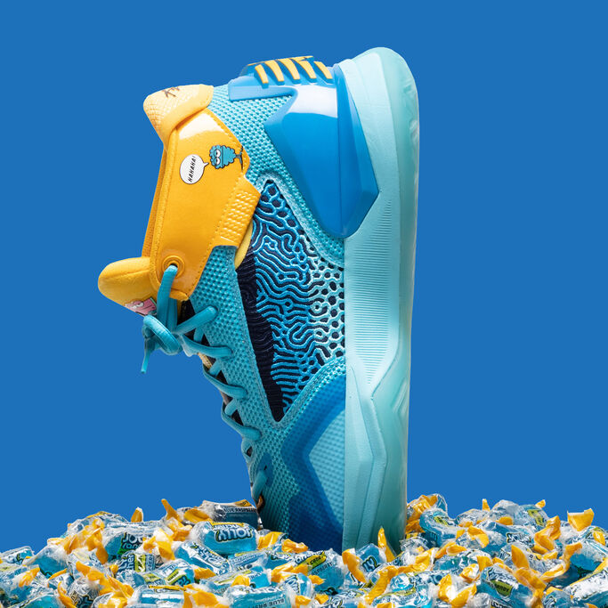 The blueberry shoe toe down inside a pile of Jolly Ranchers.