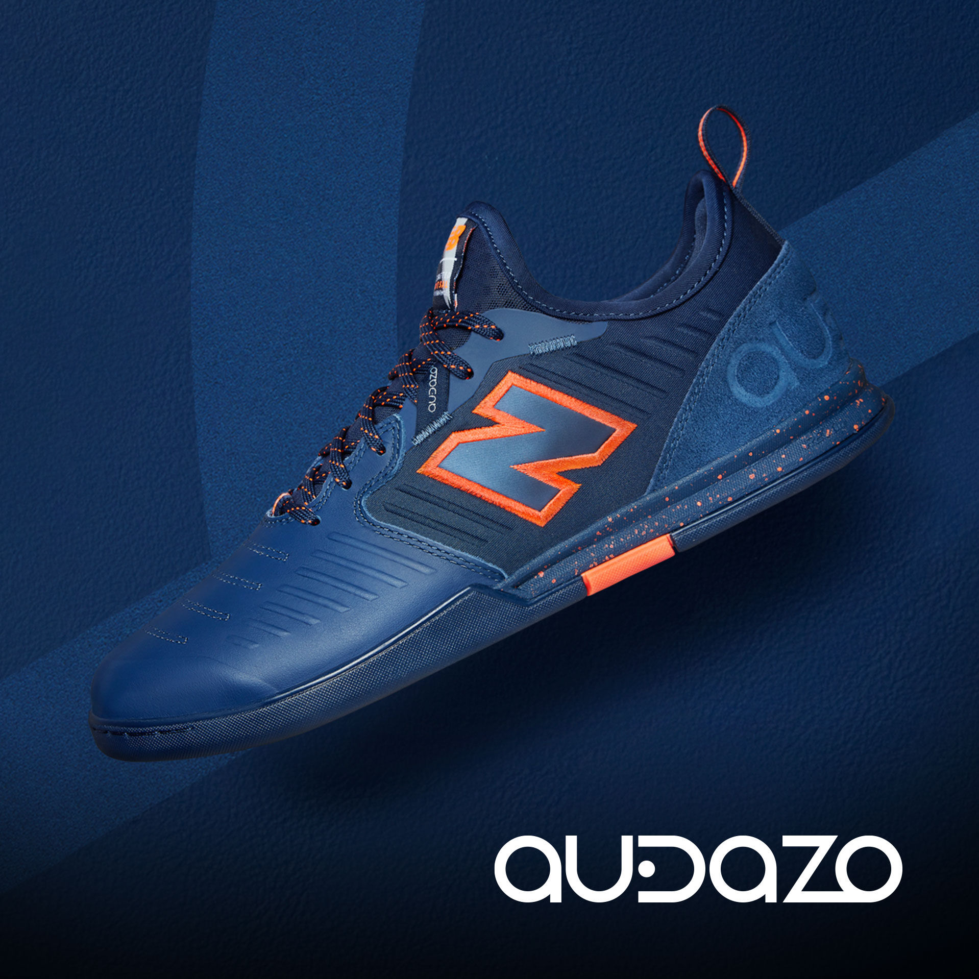 Single blue and orange Audazo shoe resting on court with Audazo logo.