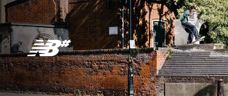 Pro skateboarder Tom Knox performing a jump on a concrete wall.