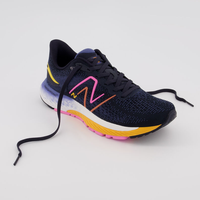 Quarter angle top down view of the navy Fresh Foam 880v12 shoe, with laces flowing to the side, on a grey background