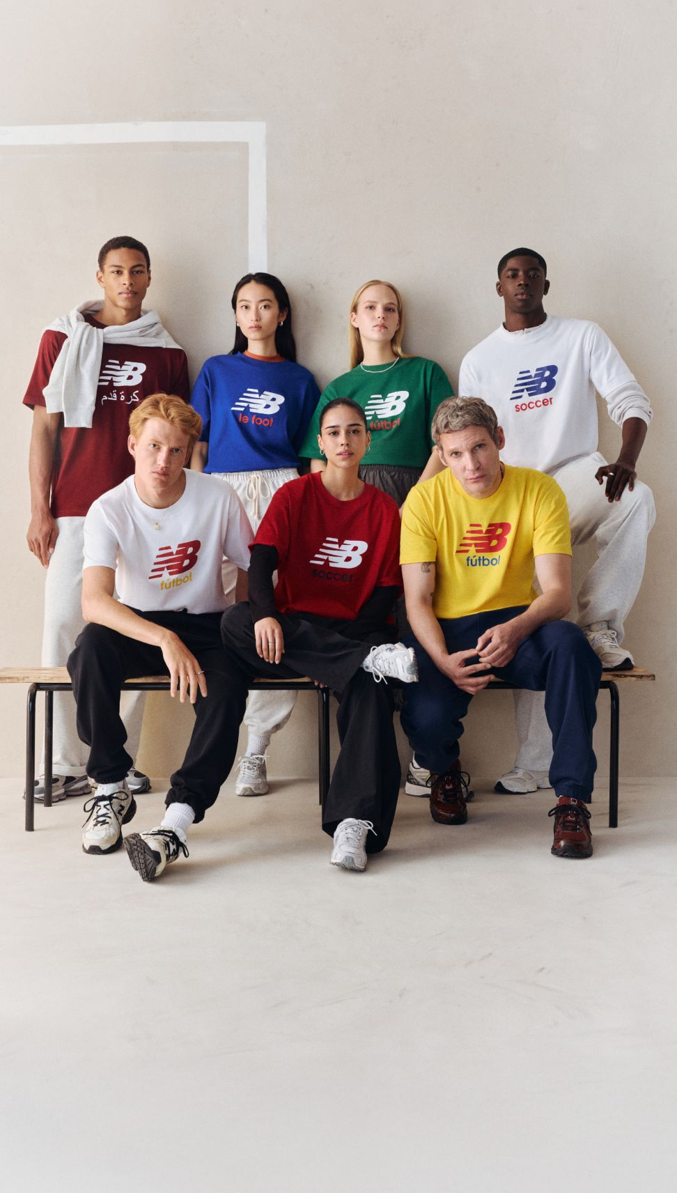 A group of people wearing soccer graphic t-shirts.