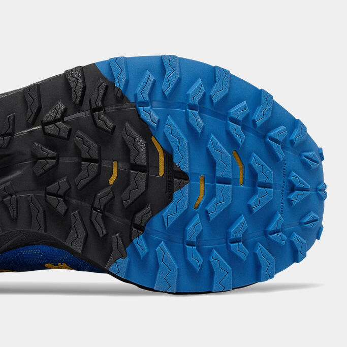 Bottom of the trail shoe focusing on the tread pattern.