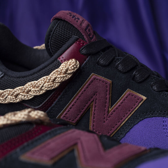 Close up image of Black History Month exclusive 574, showing gold cording around collar of shoe.