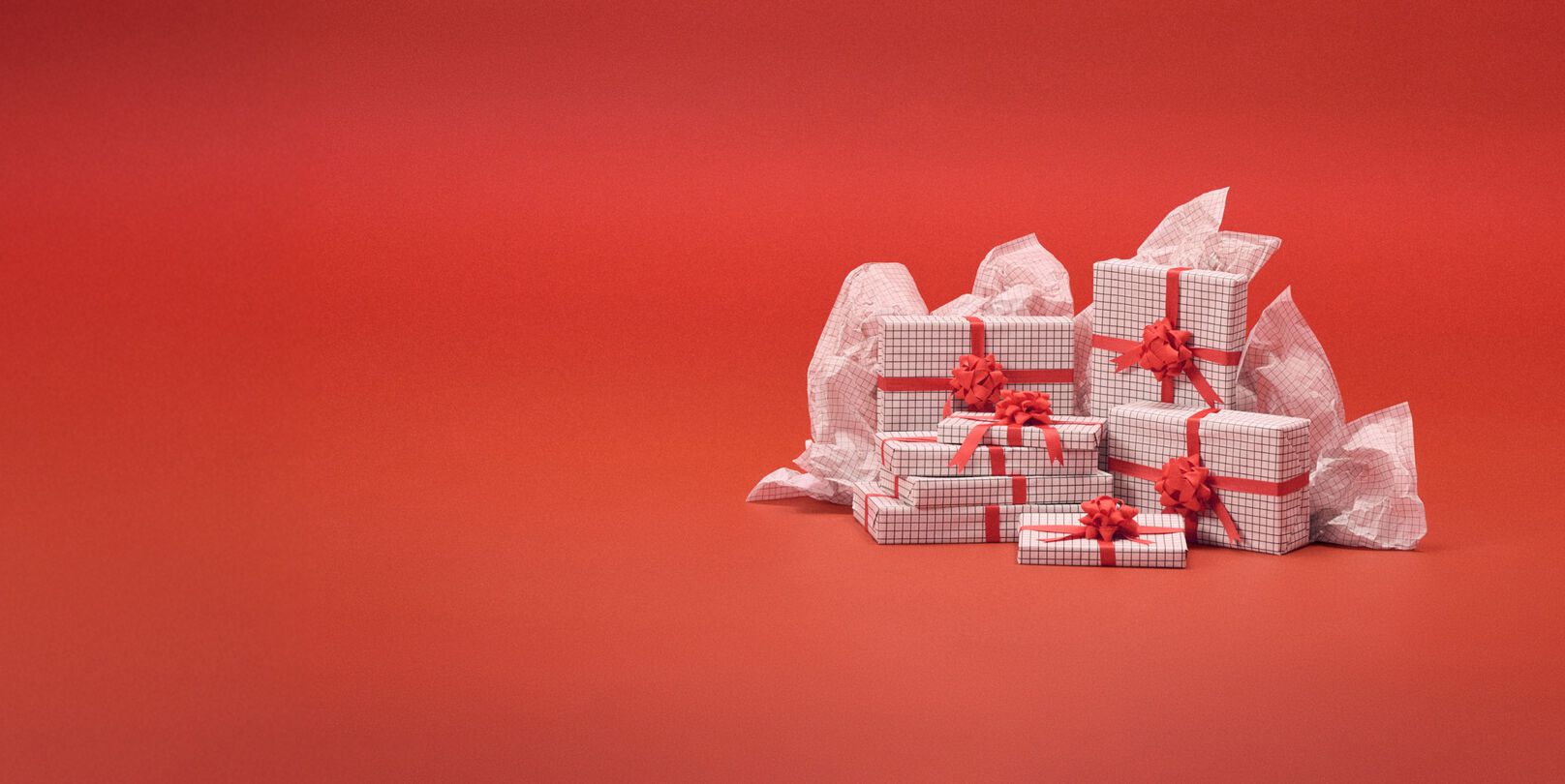 White present boxes in front of a red backdrop.