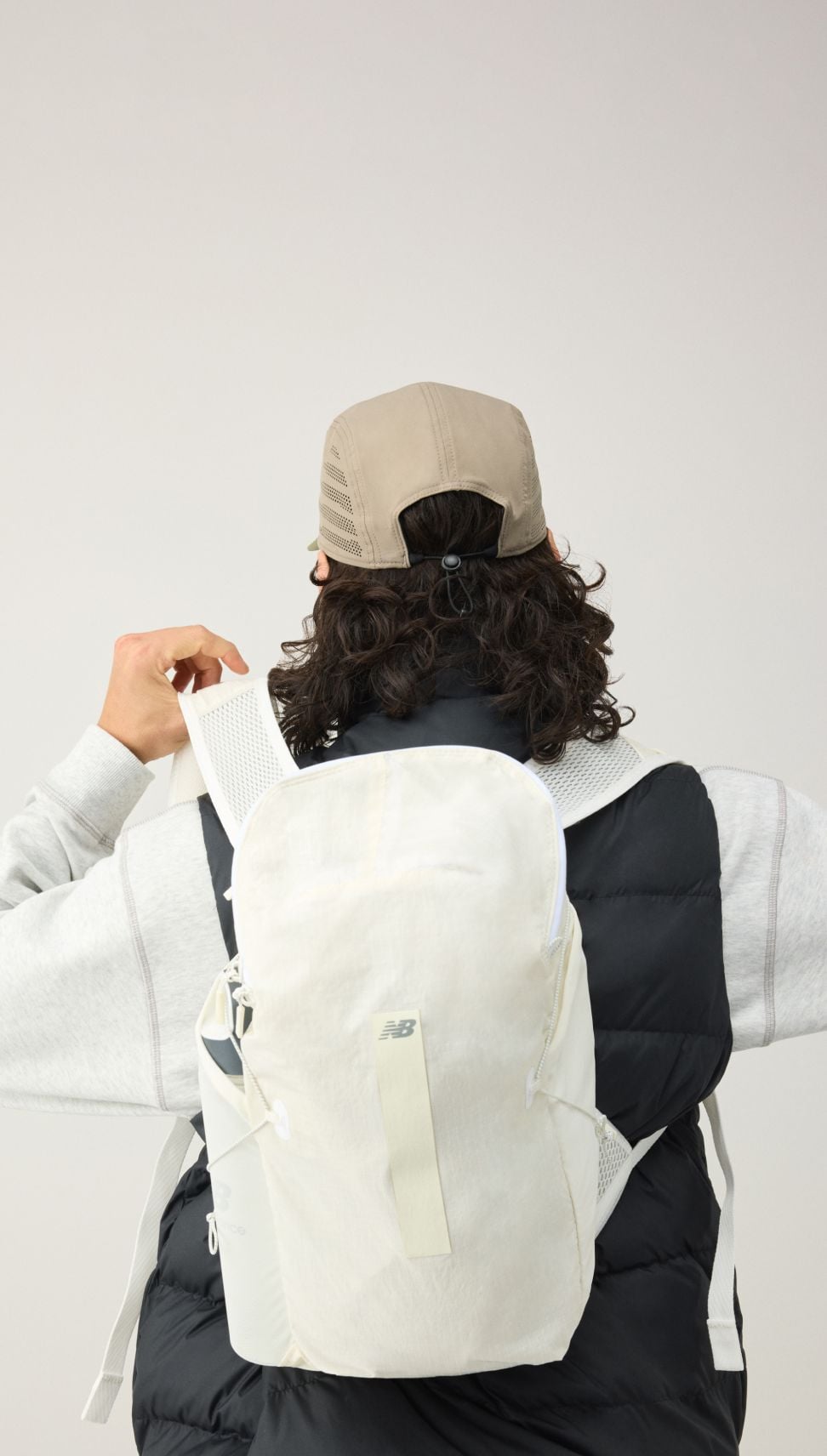 A man standing with his back turned to the viewer. 