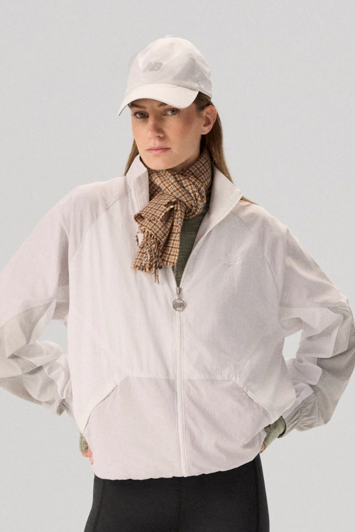 Young lady wearing NB clothing and '47 brand hat.