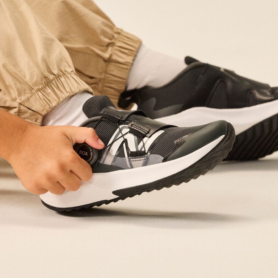 Close up of someone tightening BOA laces.