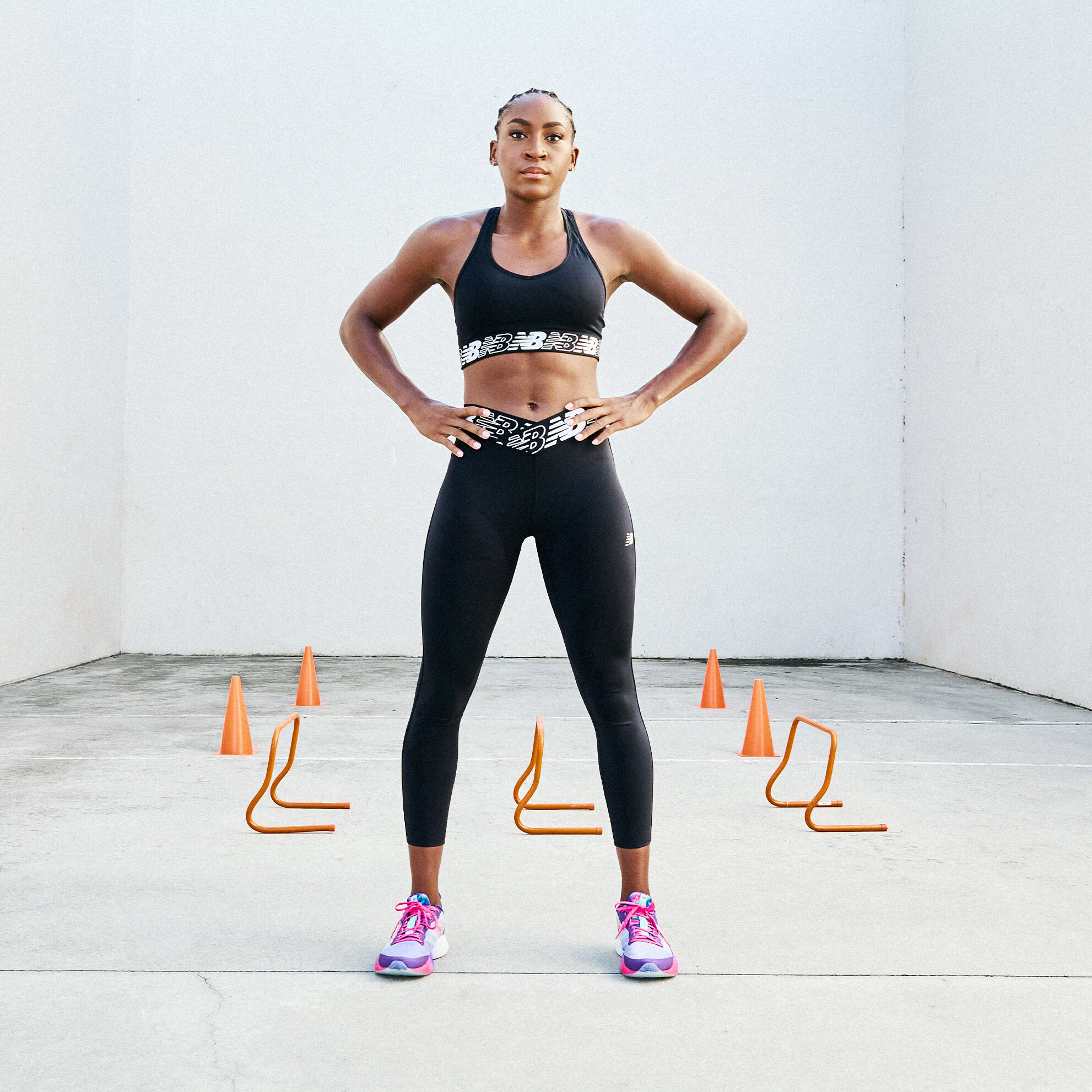 Coco Gauff wearing a black matching set and multi-colored FuelCell Shift TRs