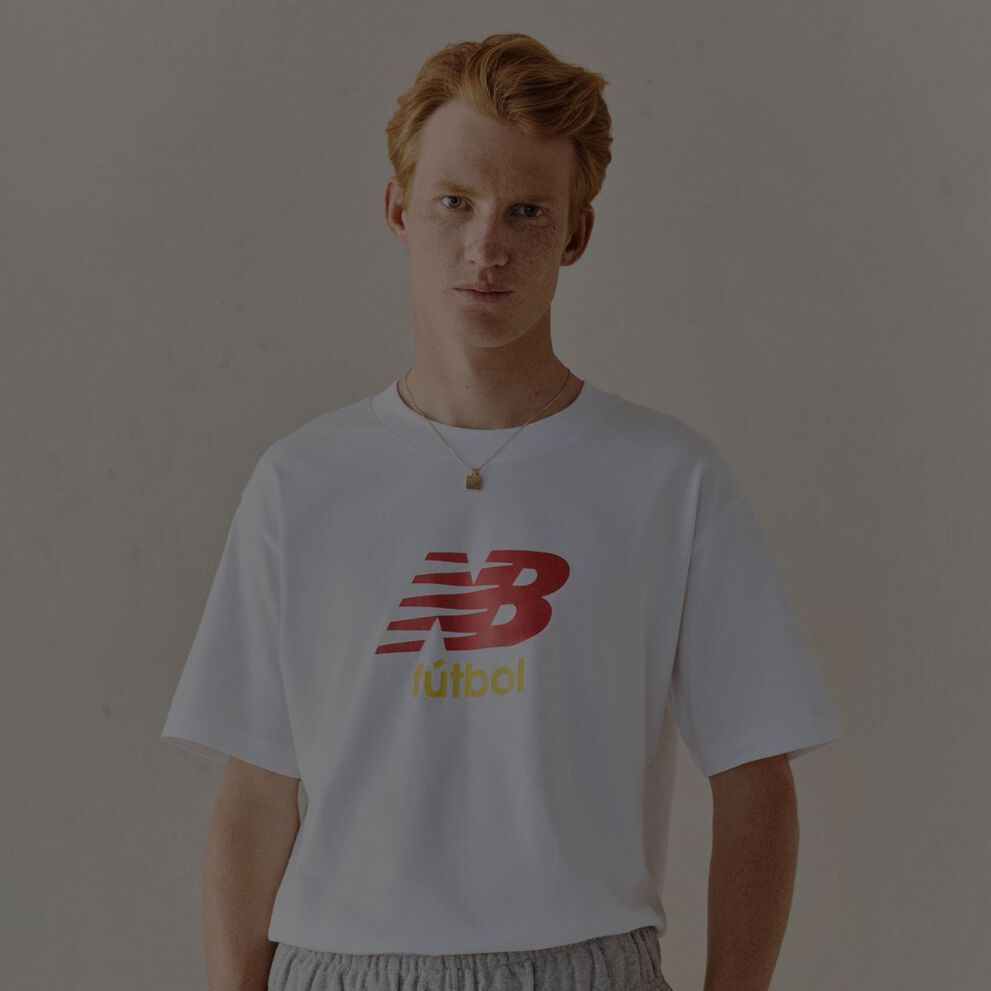 A man wearing a New Balance graphic tee.