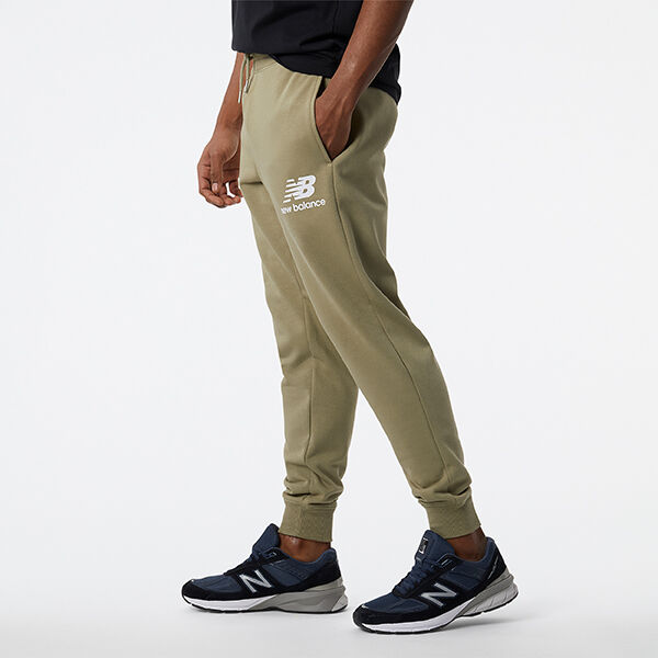 Waist-down man wearing olive-green NB joggers and dark-blue NB 990v5 sneakers
