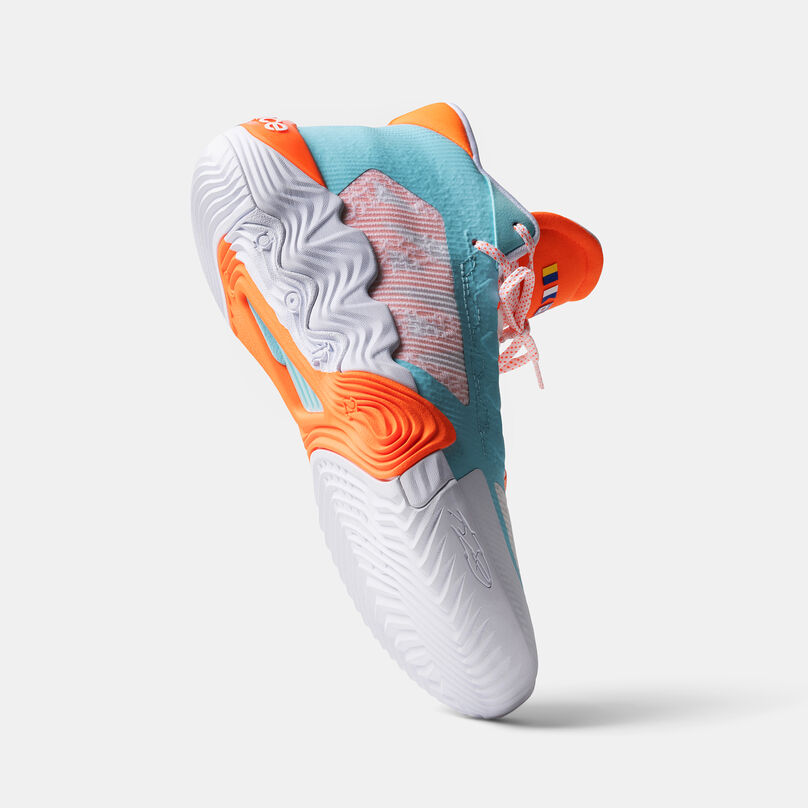 Floating white and orange basketball shoe on a grey background.