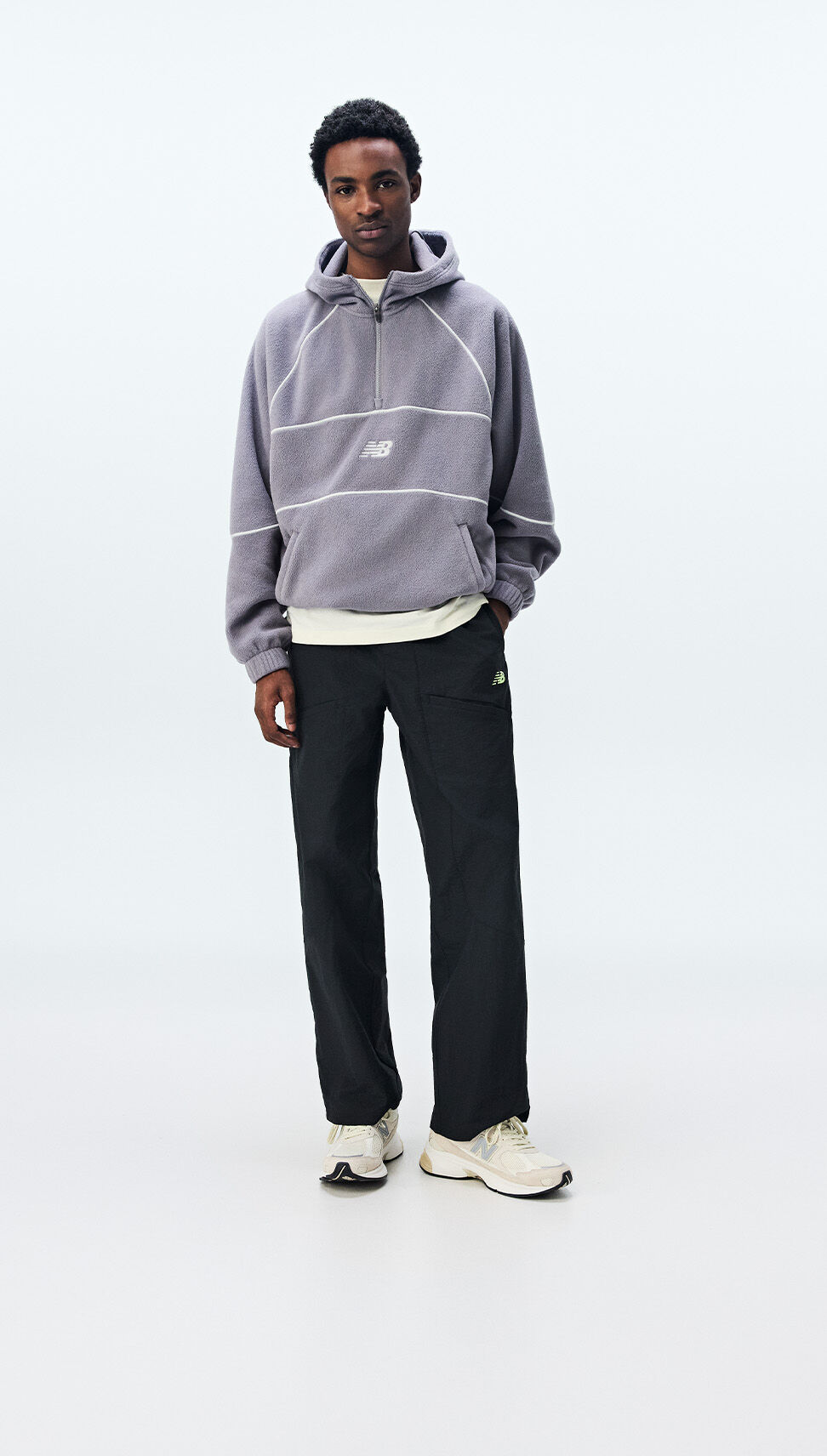  A man wearing New Balance clothing on a white background