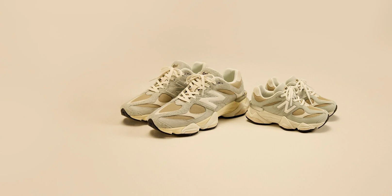Adult and kids shoes paired together on a cream background.