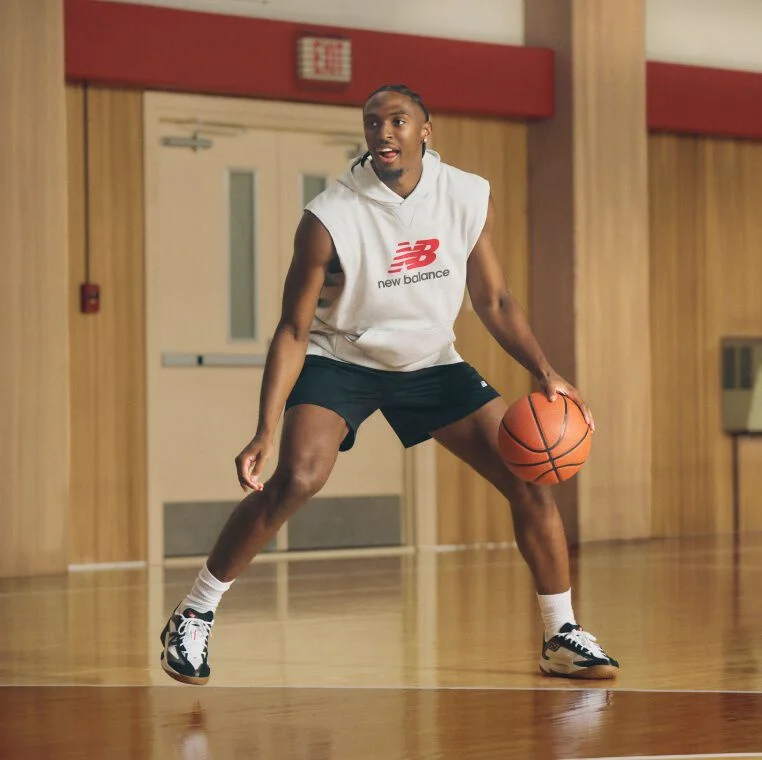 Basketball player wearing black shorts dribbling a basketball