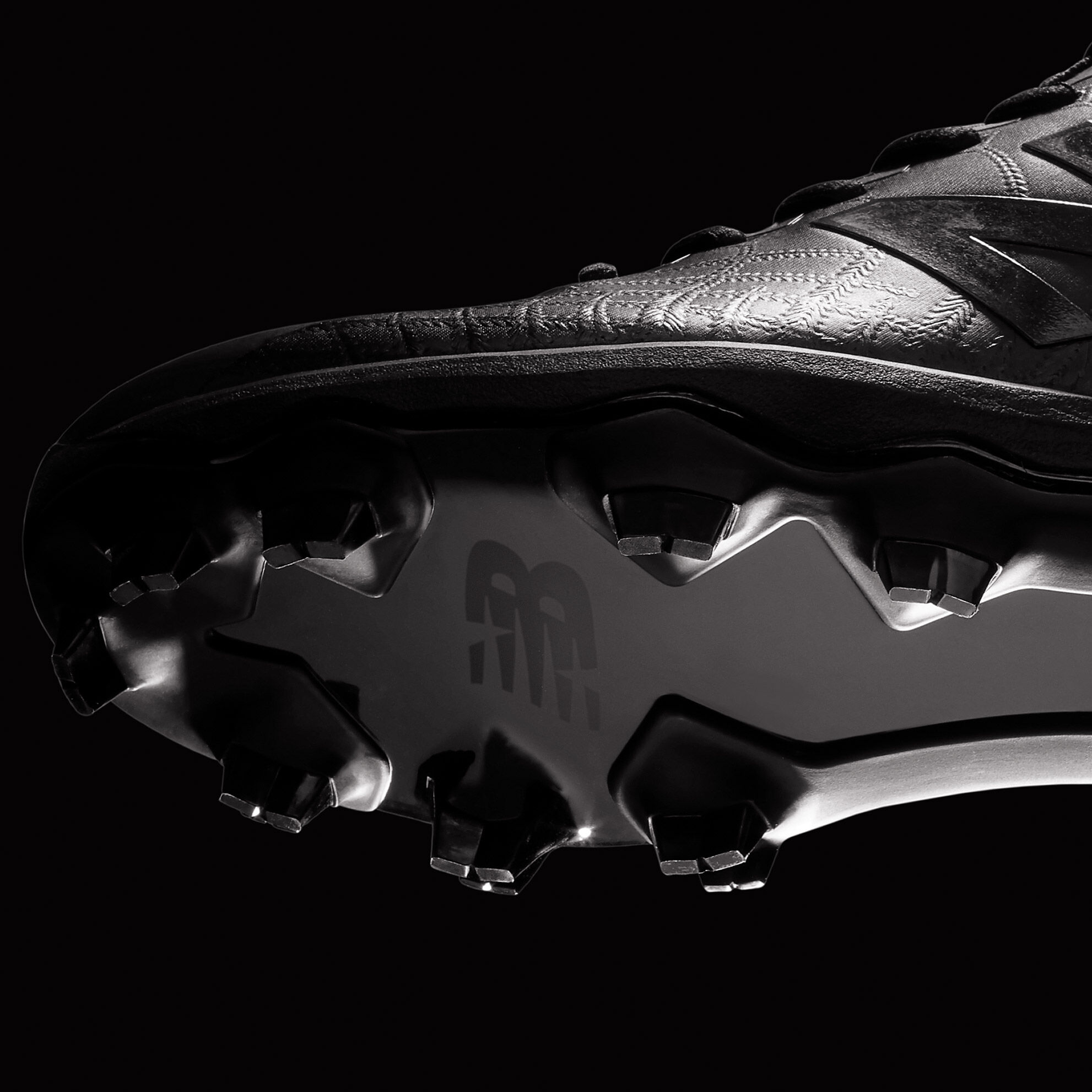 Floating, metal, all black cleat showing the spike plate.