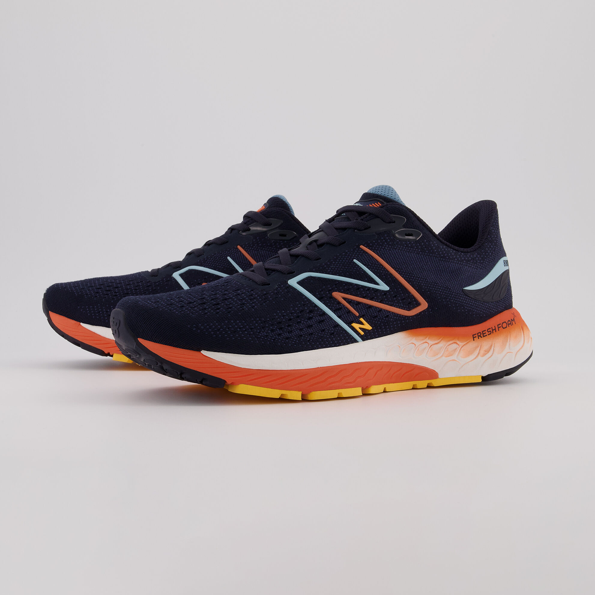 Side profile of a pair of navy Fresh Foam 880v12 shoes on a grey background