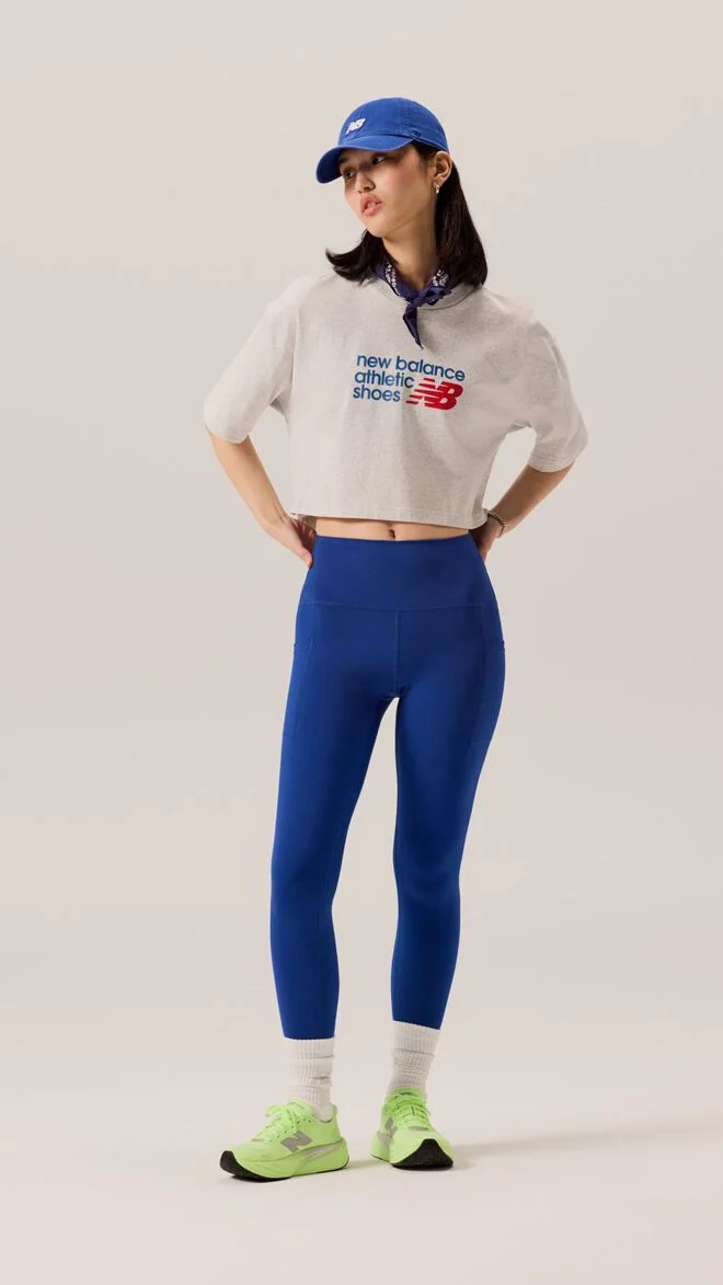 Young lady wearing blue tights and white shirt with a blue hat. 