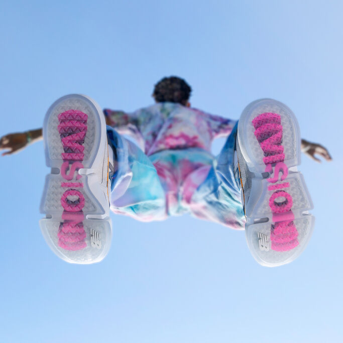 Bottom view of Jaden Smith wearing the Vision Racer with arms outstretched on blue background