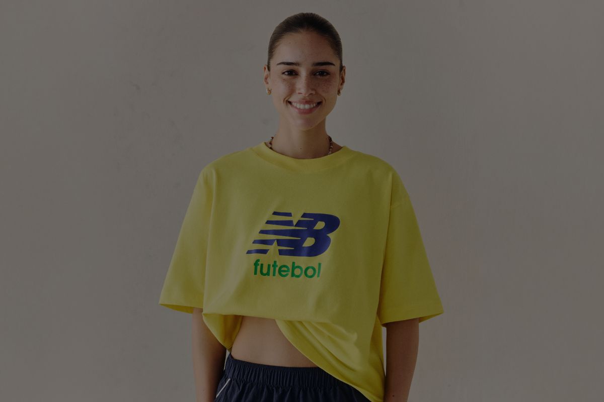 A woman wearing a New Balance graphic tee.